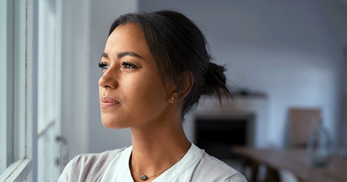 Reflective woman considering her pregnancy decision amid pressure from friends and family