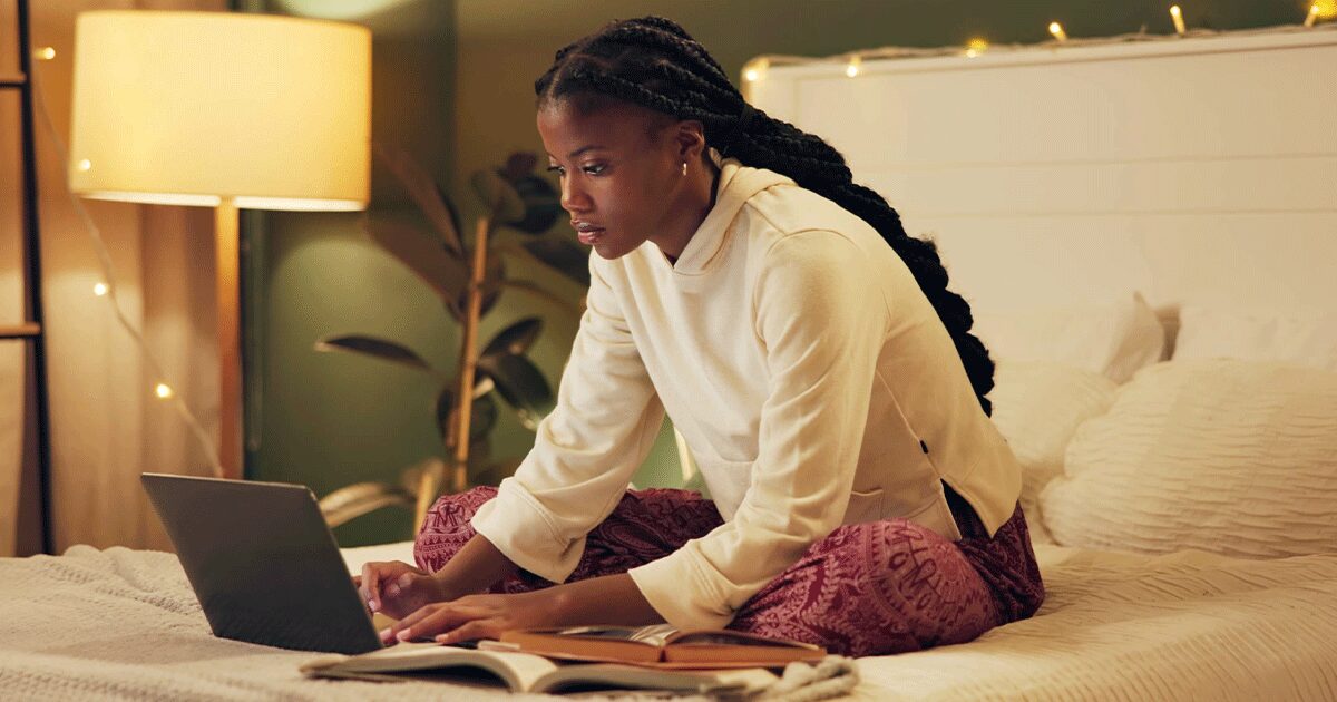 Woman researching pregnancy information and next steps after a positive pregnancy test on her laptop.